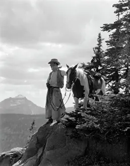 Manly Prints: 1940S Man Cowboy In Chaps Vest Hat And Kerchief With Palomino Horse On Peak Overlooking Glacier Park Montana Usa