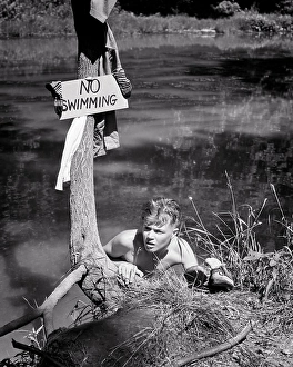 Caught Prints: 1940s SKINNY DIPPING BOY PEEKING OVER POND BANK BY A NO SWIMMING SIGN TRYING TO RETRIEVE HIS CLOTHES AND NOT GET CAUGHT