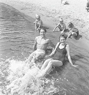 Childish Prints: 1940s summer. A young couple on the beach enjoying the sunny day