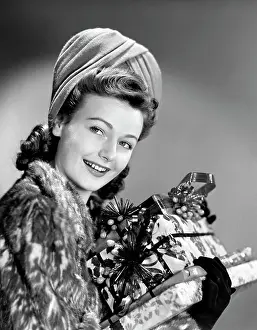 Hats Prints: 1940S Woman In Fur Coat Holding Stack Of Christmas Presents