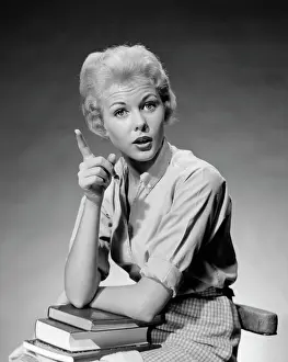 Speaking Prints: 1950S 1960S Blond Woman Stack Of Books In Her Lap Shaking Finger Pointing