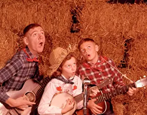Small Group Of People Prints: 1950S 1960S Two Brothers And A Sister Playing Instruments Guitars And Banjo Singing Country Music