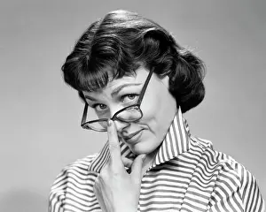 Oldtime Prints: 1950s 1960s BRUNETTE WOMAN WEARING EYE GLASSES LOOKING UP WITH DOUBTFUL SKEPTICAL EXPRESSION LOOKING AT CAMERA