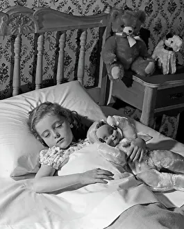 Dreams Prints: 1950S 1960S Little Girl Sleeping In Bed With Arm Around A Doll