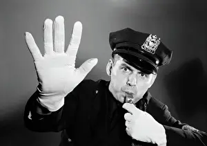 Sound Prints: 1950s 1960s POLICE MAN LOOKING AT CAMERA HAT WITH BADGE BLOWING WHISTLE WHITE GLOVED HAND UP TO HALT STOP TRAFFIC