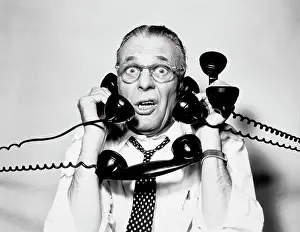 Speak Prints: 1950S 1960S Portrait Of Frazzled Businessman Trying To Answer Four Black Telephones Phones At Once