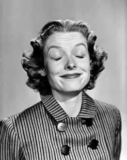 People Adults Prints: 1950S 1960S Portrait Woman Smiling Eyes Closed Making A Funny Face Wearing A Striped Dress With Buttons