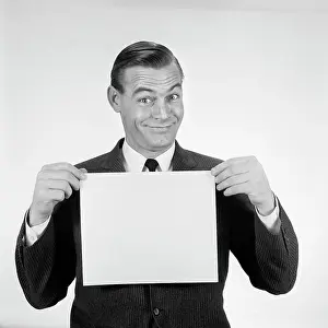 People Adults Prints: 1950S 1960S Smiling Man Funny Facial Expression Holding Up Blank Empty Placard Sign