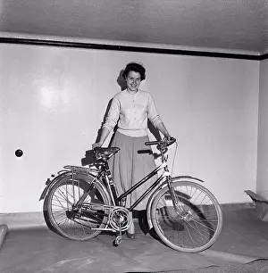 Biking Prints: 1950s bicycle. A young women with a brand new womens Crescent bicycle