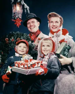 Mid Adultman Prints: 1950s FAMILY MAN WOMAN TWO KIDS HOLDING CHRISTMAS PRESENTS SMILING STANDING BENEATH LANTERN