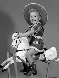 Stallion Prints: 1950S Girl Dressed As Cowgirl Riding Rocking Horse