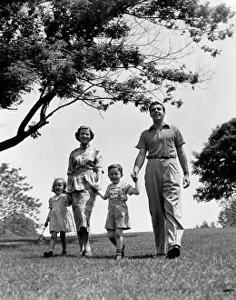 Small Group Of People Prints: 1950S Happy Family Mother Father Daughter Son Walking In Park