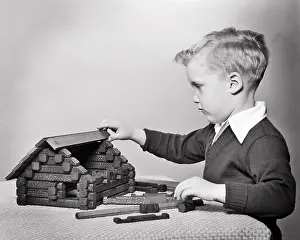Juveniles Prints: 1950s INTENT YOUNG BLOND BOY PLAYING BUILDING MODEL LOG CABIN WITH LINCOLN LOG TOY SET