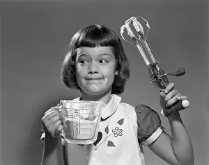 Measuring Prints: 1950S Smiling Girl Holding Measuring Cup Egg Beaters Cooking Mixing Food On Face