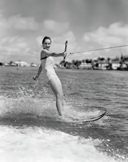Aqua Prints: 1950S Smiling Woman In Bathing Suit Water Skiing Waving One Hand