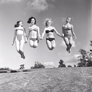 Grownups Prints: 1950s summer. A group of young women in their bikinis are happy on this summer's day