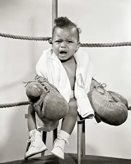 Expressions Prints: 1950s VOCAL AFRICAN AMERICAN BABY BOY FIGHTER WEARING BOXING GLOVES SITTING ON BOXING RING CORNER STOOL CRYING LOOKING