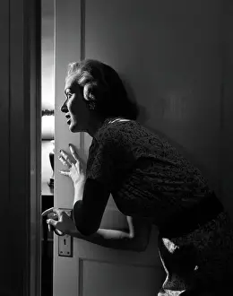 Closing Prints: 1950S Woman Peeking Through Open Door