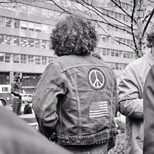 Anonymous Prints: 1960s 1970s ANONYMOUS MALE HIPPIE BACK VIEW LONG CURLY HAIR BLUE JEAN DENIM JACKET AMERICAN FLAG AND PEACE SYMBOL