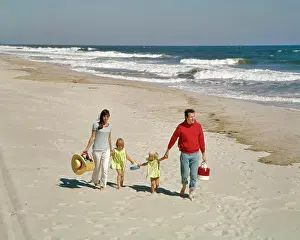 Manly Prints: 1960'S 1970'S FAMILY WALKING TOGETHER HAND HOLDING ON BEACH BY OCEAN SHORE WATER OUTDOOR MOTHER FATHER SON
