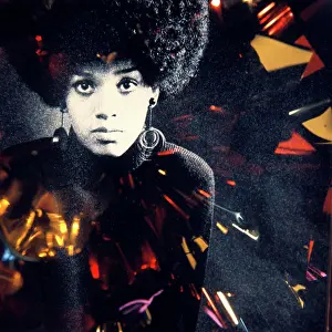 People Adults Prints: 1960S 1970S Fashion Portrait Serious African American Woman Large Afro Hair Style Hoop Earrings Special Effect Lighting