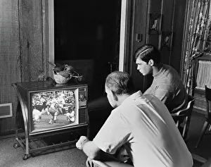 Dads Prints: 1960S 1970S Teen Boy Watching Football Game On Television With Adult Dad