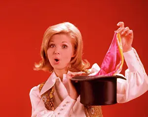 Oldtime Prints: 1960s 1970s WOMAN MAGICIAN LOOKING AT CAMERA PULLING SCARF OUT OF TOP HAT