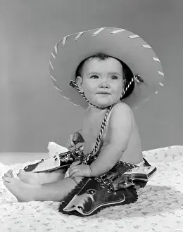 Guns Prints: 1960S Baby Girl Wearing Cowboy Hat Toy Holster And Guns Indoor