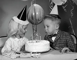 Parties Prints: 1960S Boy Blowing Out Candles On Birthday Cake