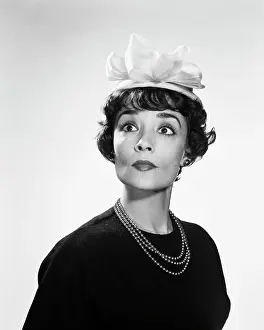 Oldtime Prints: 1960s BRUNETTE WOMAN WITH WIDE EYED EXPRESSION WEARING SILLY HAT hous