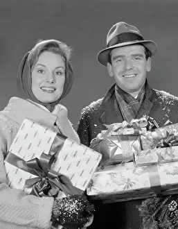Coats Prints: 1960S Couple Man And Woman Holding Wrapped Christmas Presents And Packages