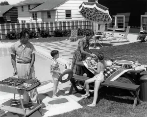 Prepare Prints: 1960S Family Of 4 In Backyard At Poolside Father Barbecuing & Mother & Children Making Preparations At Picnic Table