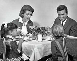 Expressions Prints: 1960s FAMILY OF FOUR EATING DINNER TOGETHER