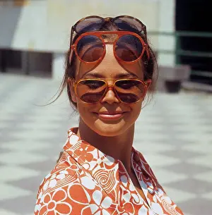 1960 S Prints: 1960s glasses. Summer of 69. The young female fashion model is wearing this years models of sunglasses and accessories