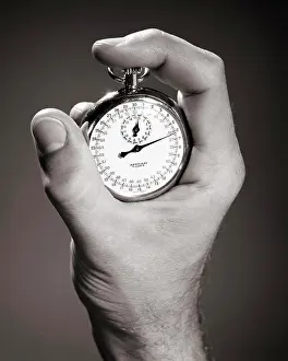 Mechanical Prints: 1960s MALE HAND HOLDING A STOPWATCH