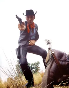 Leather Prints: 1960s MAN COWBOY IN BLACK HAT SHOOTING GUN DEAD MAN ON GROUND