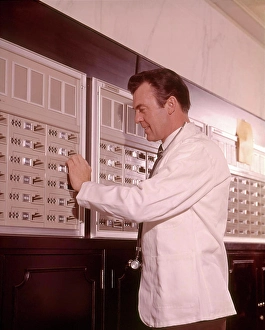 Medical And Healthcare Prints: 1960s MEDICAL DOCTOR RETRIEVING SUPPLIES FROM SECURE STORAGE