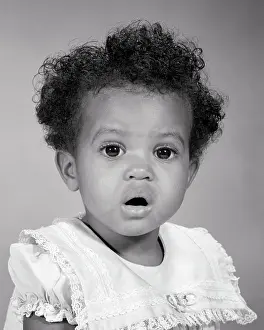 Expressions Prints: 1960s PORTRAIT OF AFRICAN-AMERICAN BABY GIRL EYES AND MOUTH WIDE OPEN FACIAL EXPRESSION OF SURPRISE WONDER AMAZEMENT