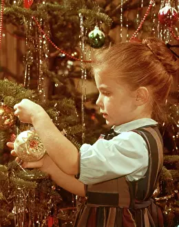Determined Prints: 1960s PROFILE SERIOUS LITTLE GIRL HANGING GLASS ORNAMENT ON CHRISTMAS TREE BRANCH