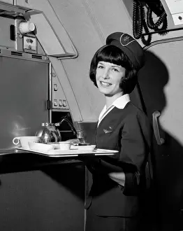 Aviation Prints: 1960S Smiling Flight Attendant Holding Tray With Coffee Service Items