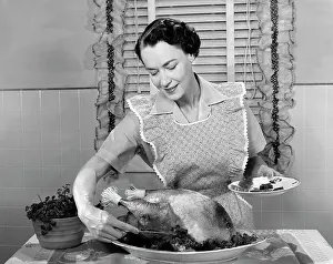 Nourishment Prints: 1960S Woman In Apron Dishing Cranberry Sauce Out Around Turkey