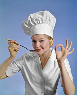 Chef Prints: 1960S WOMAN CHEF WEARING TOQUE LOOKING AT CAMERA TASTING FOOD MAKING OKAY SIGN SMILING