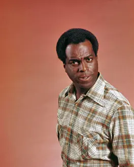 Oldtime Prints: 1970s AFRICAN AMERICAN MAN WEARING PLAID SHIRT LOOKING AT CAMERA WITH ANGRY MEAN QUESTIONING OR INQUISITIVE FACIAL