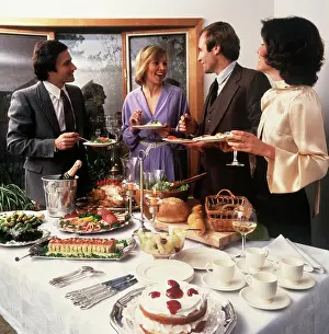 Small Group Of People Prints: 1970S Two Couples Socializing At Party Buffet Table