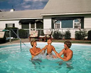 Oldtime Prints: 1970s FAMILY IN SUBURBAN BACKYARD SWIMMING POOL MAN WOMAN MOTHER FATHER PLAYING SPLASHING WITH LITTLE BOY SON
