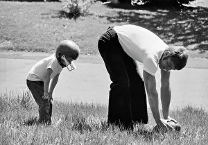 Oldtime Prints: 1970s FATHER PLAYING FOOTBALL ON GRASS IN WITH YOUNG SON