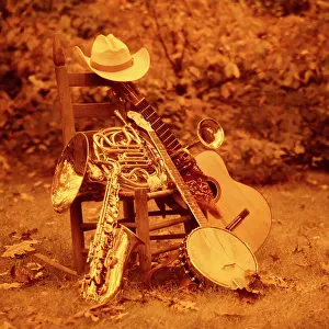 Sound Prints: 1970s STILL LIFE MUSICAL INSTRUMENTS OUTDOORS ON ROCKING CHAIR COWBOY HAT BANDANA TRUMPET SAXOPHONE