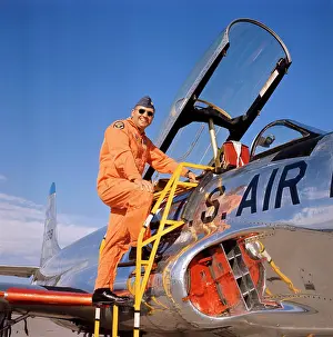 Cockpit Prints: 1970S Smiling Military Pilot Ladder Climbing Enter Cockpit Jet Wearing Orange Flight Jump Suit Pilots Men