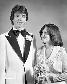 Expressions Prints: 1970s TEEN COUPLE DRESSED UP FOR PROM DANCE FORMAL ATTIRE GIRL HOLDING BOUQUET LOOKING UP AT TALL BOY