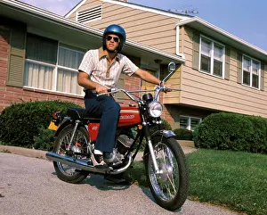 Biking Prints: 1970S Young Man Blue Helmet Sitting On Motorcycle In Driveway Suburban House Bike Motorcycles Men